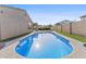 Inviting pool in backyard with artificial turf, surrounded by mature landscaping for privacy at 2894 E Nolan Pl, Chandler, AZ 85249
