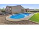 Sparkling pool and backyard with artificial turf and meticulous landscaping provide a relaxing outdoor oasis at 2894 E Nolan Pl, Chandler, AZ 85249