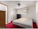 Bedroom featuring red carpet, storage shelves, a bed, and doorway to bathroom at 300 S Val Vista Dr # 167, Mesa, AZ 85204