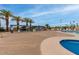 Beautiful view of community pool with palm trees, lounge seating, and cabana area at 300 S Val Vista Dr # 167, Mesa, AZ 85204