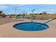Relaxing community pool area featuring hot tub, pool, lounge chairs, and palm trees at 300 S Val Vista Dr # 167, Mesa, AZ 85204