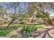 Beautiful backyard with a well-maintained lawn, mature trees, and a cozy patio area perfect for outdoor relaxation at 302 E Orange Dr, Phoenix, AZ 85012