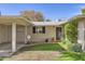 Inviting single-story home with an open carport, a well-manicured lawn, and a neatly landscaped front entrance at 302 E Orange Dr, Phoenix, AZ 85012