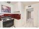 Cozy kitchen featuring classic white cabinets, a gas range, and a functional layout at 302 E Orange Dr, Phoenix, AZ 85012