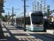 Silver Metro Light Rail is at the station. Poles and the tracks are also visible at 302 E Orange Dr, Phoenix, AZ 85012