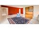 Bright living space with a vibrant red accent wall, a stylish rug, and a comfortable seating arrangement at 302 E Orange Dr, Phoenix, AZ 85012