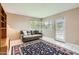 Bright living room with a gray couch, a textured rug, and lots of natural light from the window at 302 E Orange Dr, Phoenix, AZ 85012