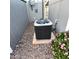 View of the home's A/C unit and desert landscaping with flowering plants at 303 S Recker Rd # 74, Mesa, AZ 85206