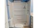 Bathroom with a white shower stall, blue paneling, and white toilet at 303 S Recker Rd # 74, Mesa, AZ 85206