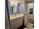 Bathroom with blue paneled walls, white cabinets, and white sink at 303 S Recker Rd # 74, Mesa, AZ 85206