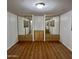 Bright bedroom with laminate floors, two mirrored closets, and storage at 303 S Recker Rd # 74, Mesa, AZ 85206