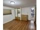 Bright bedroom with laminate floors, mirrored closet, and dresser at 303 S Recker Rd # 74, Mesa, AZ 85206