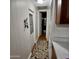 Long, narrow hallway with wood-look flooring, white walls, and an interesting key holder at 303 S Recker Rd # 74, Mesa, AZ 85206