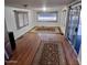 Open living room with wood floors, neutral walls, and large windows at 303 S Recker Rd # 74, Mesa, AZ 85206