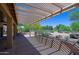Inviting back patio features a pergola providing shade and a serene outdoor living space at 3147 N Couples Dr, Goodyear, AZ 85395
