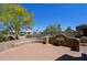 Relaxing back patio features a decorative wall and seating, great for outdoor entertaining and leisure at 3147 N Couples Dr, Goodyear, AZ 85395