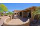 Extended back patio features an overhead pergola, brick flooring, and a decorative wall and landscaping at 3147 N Couples Dr, Goodyear, AZ 85395