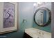 Bathroom features decorative mirror, framed floral art, and vanity sink at 3147 N Couples Dr, Goodyear, AZ 85395