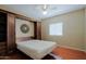 Bedroom showcasing hardwood floors, built-in shelving and a murphy bed for functional living at 3147 N Couples Dr, Goodyear, AZ 85395