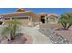 Charming home with a three-car garage, desert landscaping, and a walkway to the front door at 3147 N Couples Dr, Goodyear, AZ 85395