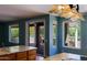 Bright eat-in kitchen with granite countertops, island with cooktop, and sliding door access to backyard at 3147 N Couples Dr, Goodyear, AZ 85395