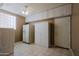 Large laundry room with tile flooring, built-in cabinets, washer/dryer hookups, and backyard access at 3147 N Couples Dr, Goodyear, AZ 85395