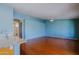Open-concept living room featuring hardwood floors and serene blue walls at 3147 N Couples Dr, Goodyear, AZ 85395