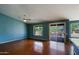 Spacious living room with hardwood floors, ceiling fan and sliding door access to the backyard at 3147 N Couples Dr, Goodyear, AZ 85395