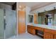 Main bathroom with glass shower, dual vanity, and tiled floors at 3147 N Couples Dr, Goodyear, AZ 85395