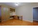 Office space with hardwood floors, built-in desk and wall cabinet at 3147 N Couples Dr, Goodyear, AZ 85395
