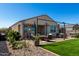 This cozy backyard features pavers, a fire pit, seating, and synthetic grass at 3670 E Sandoval Dr, San Tan Valley, AZ 85140