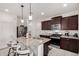 Modern kitchen featuring stainless steel appliances, granite countertops, and a breakfast bar with seating at 3670 E Sandoval Dr, San Tan Valley, AZ 85140