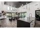 Bright open kitchen with a large island, stainless steel sink and sliding doors leading to an outdoor area at 3670 E Sandoval Dr, San Tan Valley, AZ 85140