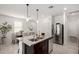 Well-lit kitchen with stainless steel appliances, granite countertops, and open access to the dining area at 3670 E Sandoval Dr, San Tan Valley, AZ 85140