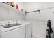 Functional laundry room featuring modern washer and dryer units and shelving, providing convenience and organization at 3670 E Sandoval Dr, San Tan Valley, AZ 85140