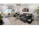 Modern living room featuring a gray sectional sofa, a ceiling fan, and sliding glass doors to a patio at 3670 E Sandoval Dr, San Tan Valley, AZ 85140