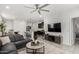 Open-concept living area with gray leather sectional, neutral decor, and a mounted TV at 3670 E Sandoval Dr, San Tan Valley, AZ 85140