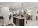 Open-concept living space with stainless appliances, island seating, and an adjacent living room and dining area at 3670 E Sandoval Dr, San Tan Valley, AZ 85140