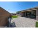 Outdoor patio features pavers, artificial grass, string lights, and a view of the pool at 3907 S 75Th Dr, Phoenix, AZ 85043