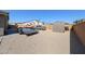 Spacious backyard with gravel landscaping, shed, trailer and classic trucks at 3907 S 75Th Dr, Phoenix, AZ 85043