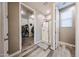 Bright bathroom showcasing a modern shower and a well-organized walk-in closet at 3907 S 75Th Dr, Phoenix, AZ 85043