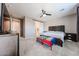 Spacious bedroom with carpeting, fan, and natural light at 3907 S 75Th Dr, Phoenix, AZ 85043