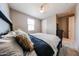 Neutral bedroom with a comfortable bed, soft linens, and a dark wood nightstand, creating a cozy ambiance at 3907 S 75Th Dr, Phoenix, AZ 85043