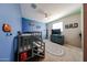 Fun ' bedroom featuring a bunk bed with a slide, blue walls, and playful decor for an engaging space at 3907 S 75Th Dr, Phoenix, AZ 85043