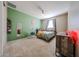 Stylish bedroom with a green accent wall, unique hanging chair, and modern decor for a personalized touch at 3907 S 75Th Dr, Phoenix, AZ 85043