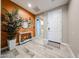 Inviting entryway featuring an orange accent wall and wood-look tile flooring, creating a warm welcome at 3907 S 75Th Dr, Phoenix, AZ 85043