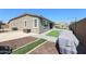 Back exterior with pavers, turf, and string lights, perfect for outdoor living at 3907 S 75Th Dr, Phoenix, AZ 85043