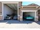 Three-car garage includes two vintage cars with one under a cover and a newer car in the third space at 3907 S 75Th Dr, Phoenix, AZ 85043