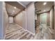 Bright hallway leading to the front door and an adjoining half bathroom with stylish cabinetry at 3907 S 75Th Dr, Phoenix, AZ 85043