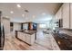 Modern kitchen with an island flowing into the living room area that includes a fireplace at 3907 S 75Th Dr, Phoenix, AZ 85043
